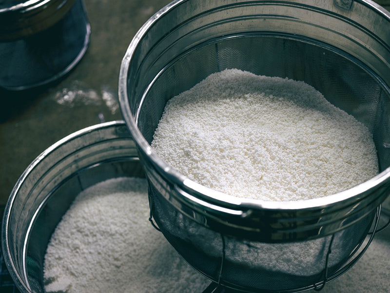 White rice in round steel mesh baskets.
