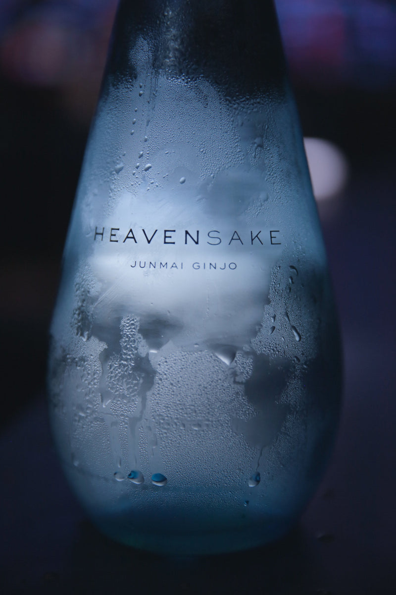 Condensation on a blue HEAVENSAKE Junmai Ginjo bottle.