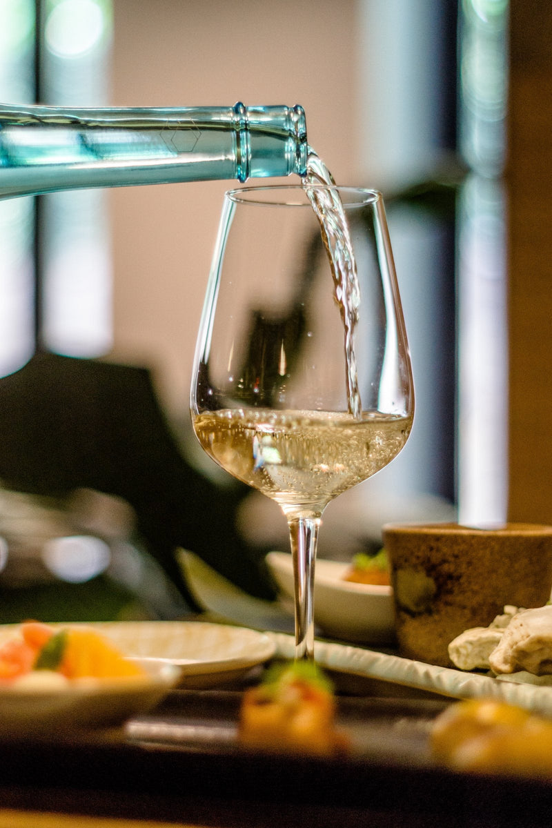 LABEL AZUR poured into a white wine glass.