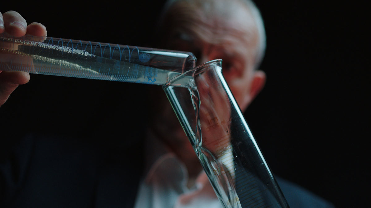 Régis Camus composing an Assemblage, pouring between graduated vessels.